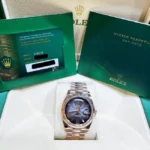 Rolex Day-Date 40 Slate Ombré Roman Dial Everose Gold 228235 watch on a box